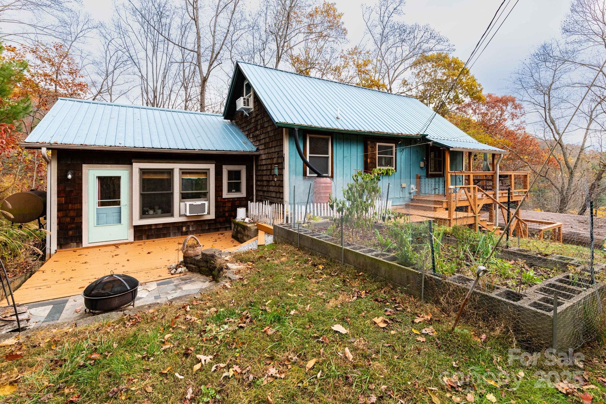 35 Norton Br Road Marshall, NC 28753 - Photo 3 of 35 a view of a house with table and chairs in a patio