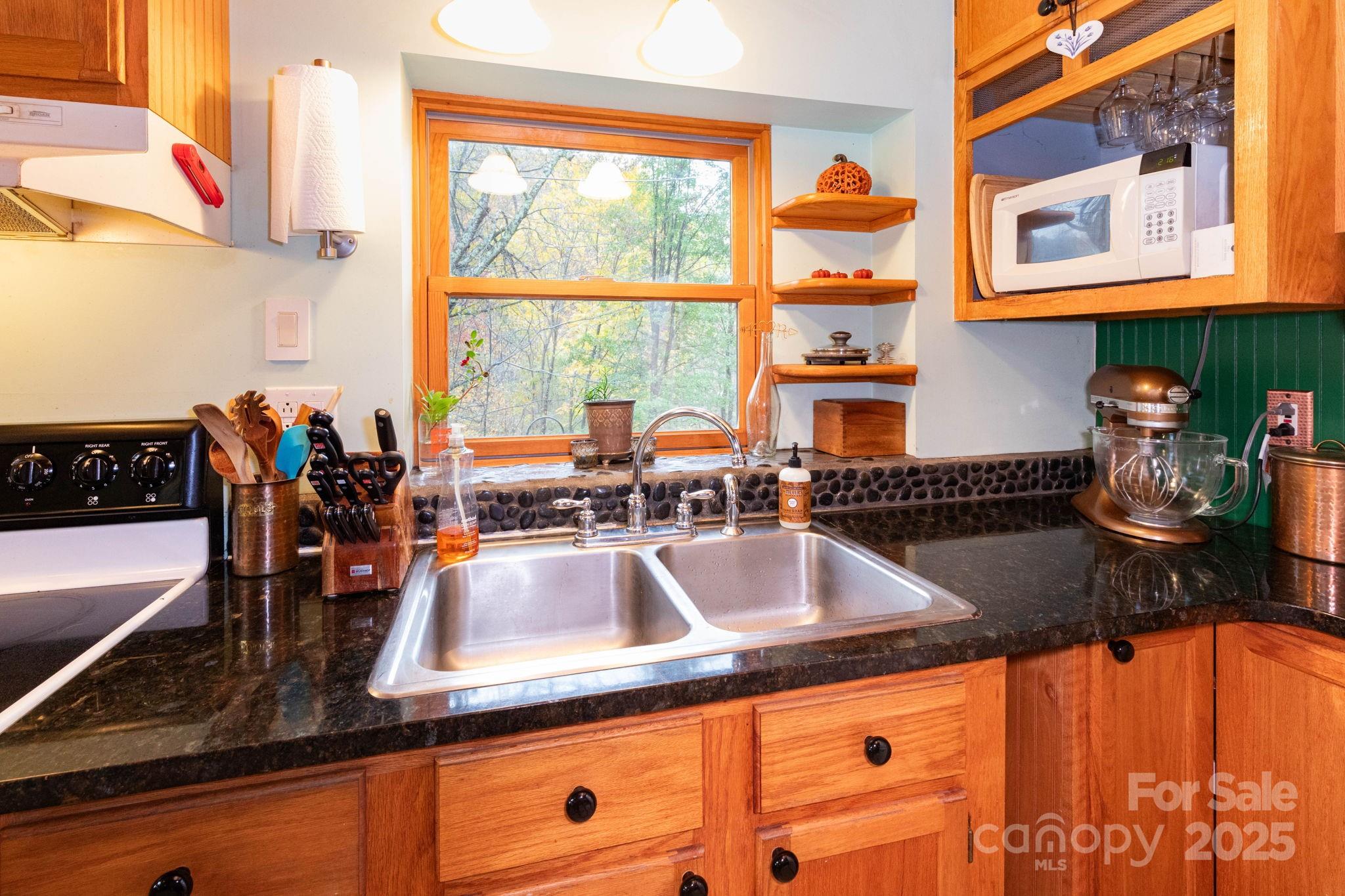 35 Norton Br Road Marshall, NC 28753 - Photo 9 of 35 a kitchen with stainless steel appliances granite countertop a sink and a wooden cabinets