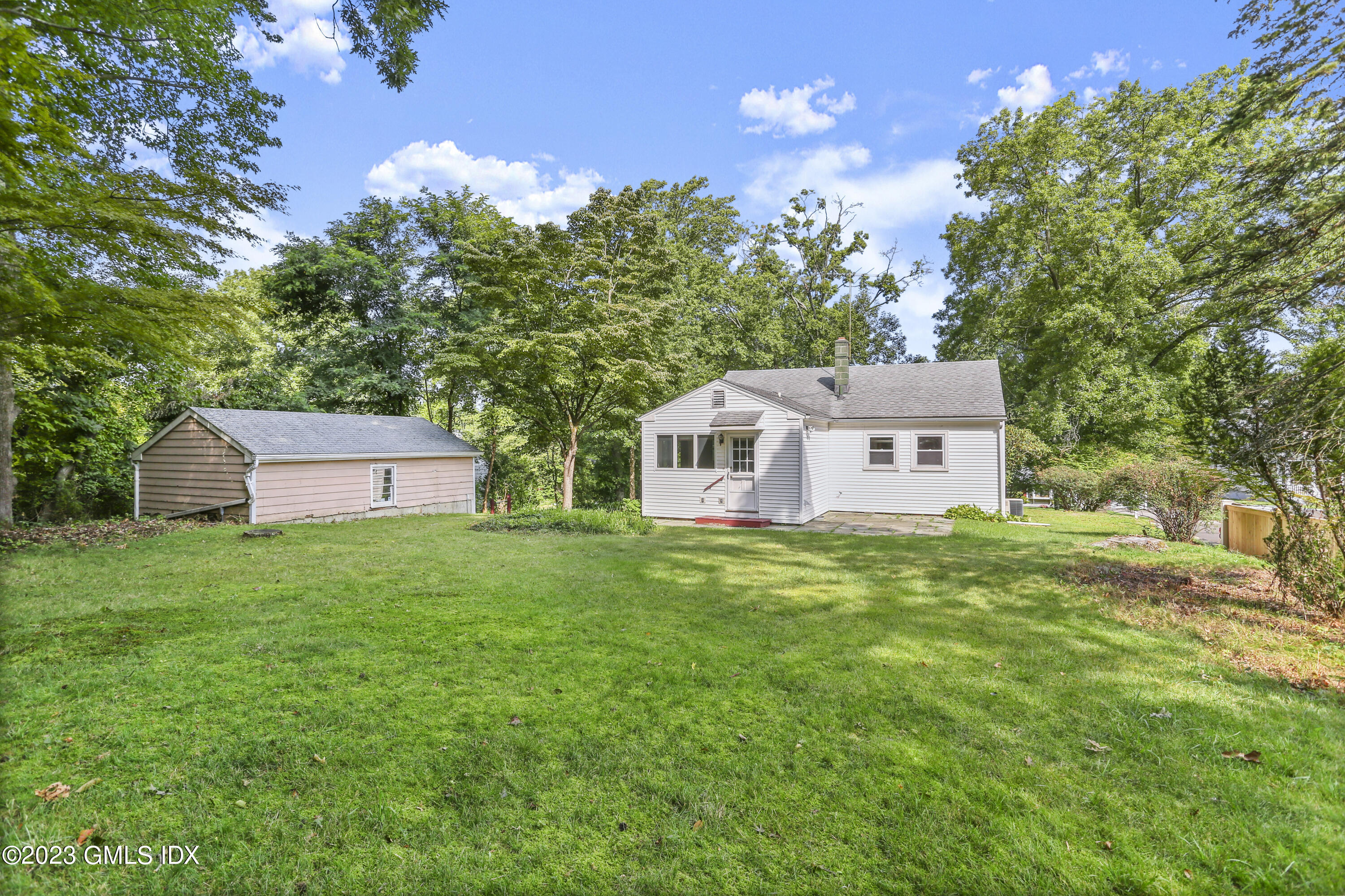 25 Circle Drive Greenwich, CT 06830 - Photo 2 of 2 a view of a house with a big yard and a large tree