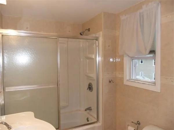 a bathroom with a shower and a toilet