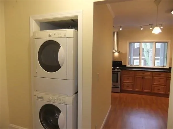 a view of a kitchen with a sink washer and dryer