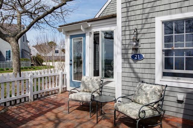 21 Milestone Way Mashpee, MA 02649 - Photo 2 of 27 a view of a chair and table in the balcony