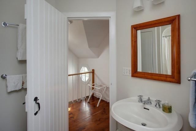 21 Milestone Way Mashpee, MA 02649 - Photo 23 of 27 a bathroom with a sink and mirror