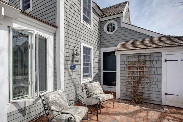 21 Milestone Way Mashpee, MA 02649 - Photo 3 of 27 a view of a patio with table and chairs and potted plants