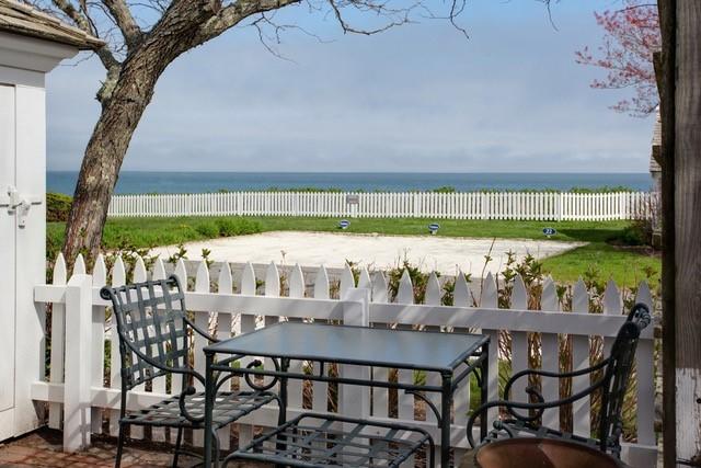 21 Milestone Way Mashpee, MA 02649 - Photo 4 of 27 a table and chairs with potted plants