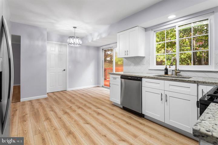 2807 Falling Brook Terrace Hyattsville, MD 20783 - Photo 13 of 48 a kitchen with a sink window and cabinets
