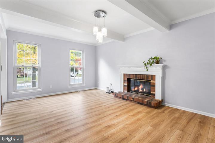 2807 Falling Brook Terrace Hyattsville, MD 20783 - Photo 16 of 48 a view of an empty room with wooden floor fireplace and a window