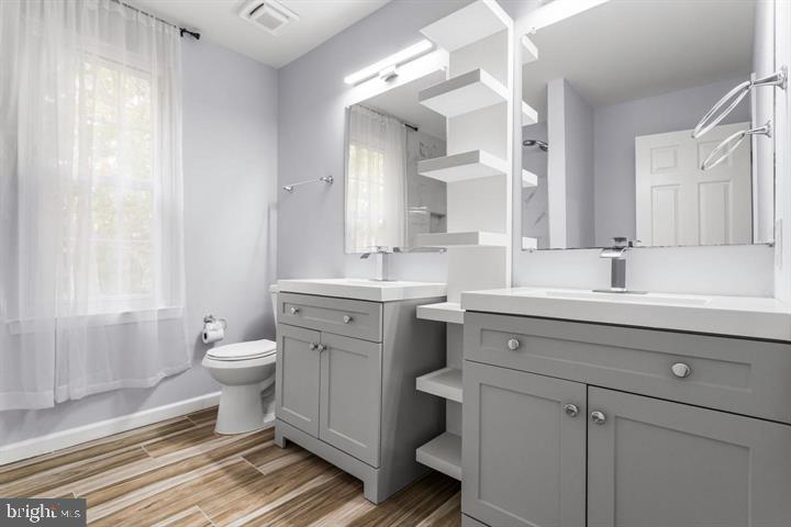 2807 Falling Brook Terrace Hyattsville, MD 20783 - Photo 23 of 48 a bathroom with a toilet sink double vanity and window
