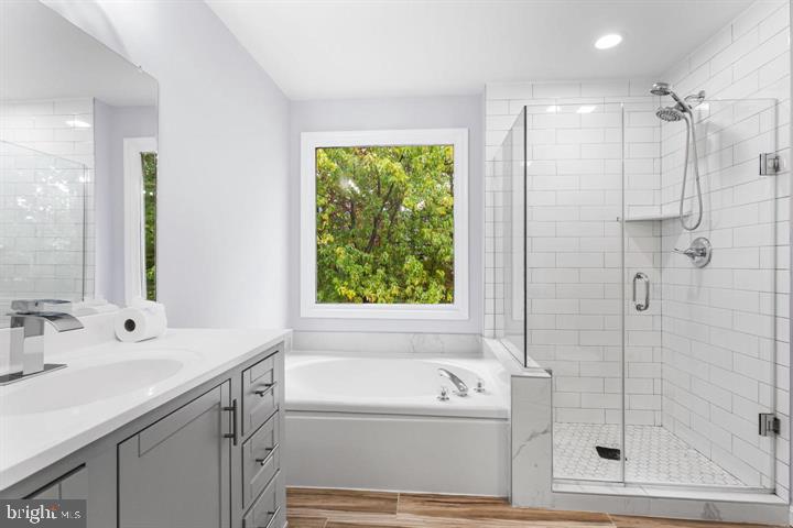 2807 Falling Brook Terrace Hyattsville, MD 20783 - Photo 27 of 48 a bathroom with a bathtub sink vanity and window