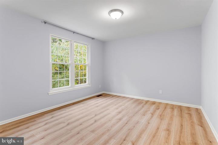 2807 Falling Brook Terrace Hyattsville, MD 20783 - Photo 28 of 48 an empty room with wooden floor and windows