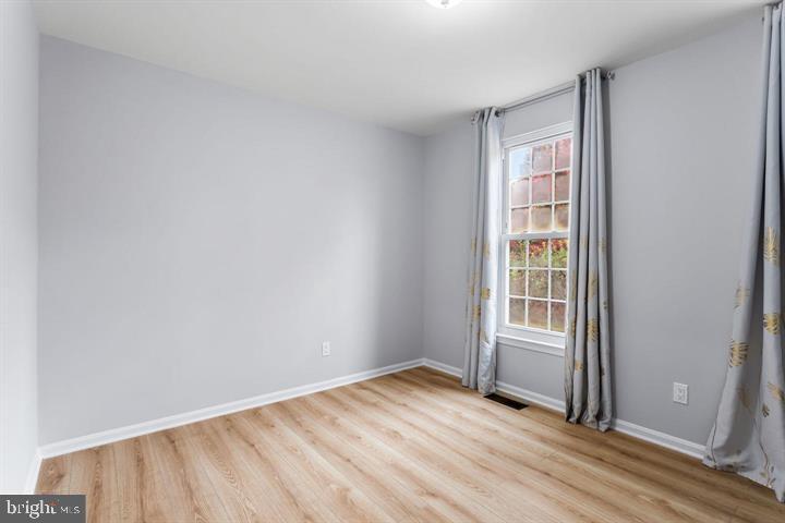 2807 Falling Brook Terrace Hyattsville, MD 20783 - Photo 34 of 48 an empty room with wooden floor and windows