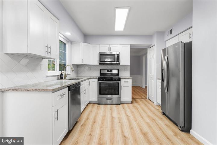 2807 Falling Brook Terrace Hyattsville, MD 20783 - Photo 10 of 48 a kitchen with granite countertop a refrigerator and a sink