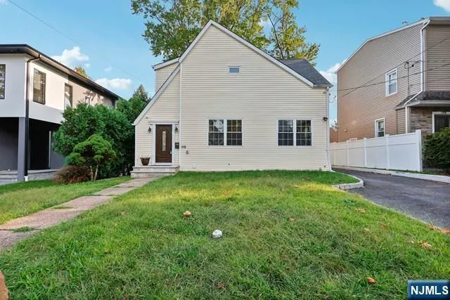 a view of backyard of house with green space