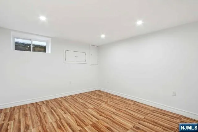 a view of room with wooden floor and fan