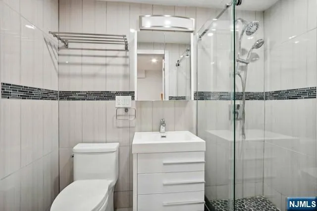 a bathroom with a sink mirror vanity and toilet