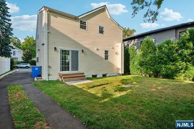 a view of a backyard with plants and a patio