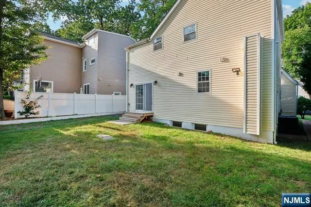 a view of backyard of house with outdoor seating and green space