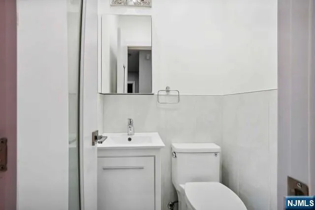 a bathroom with a toilet sink and mirror