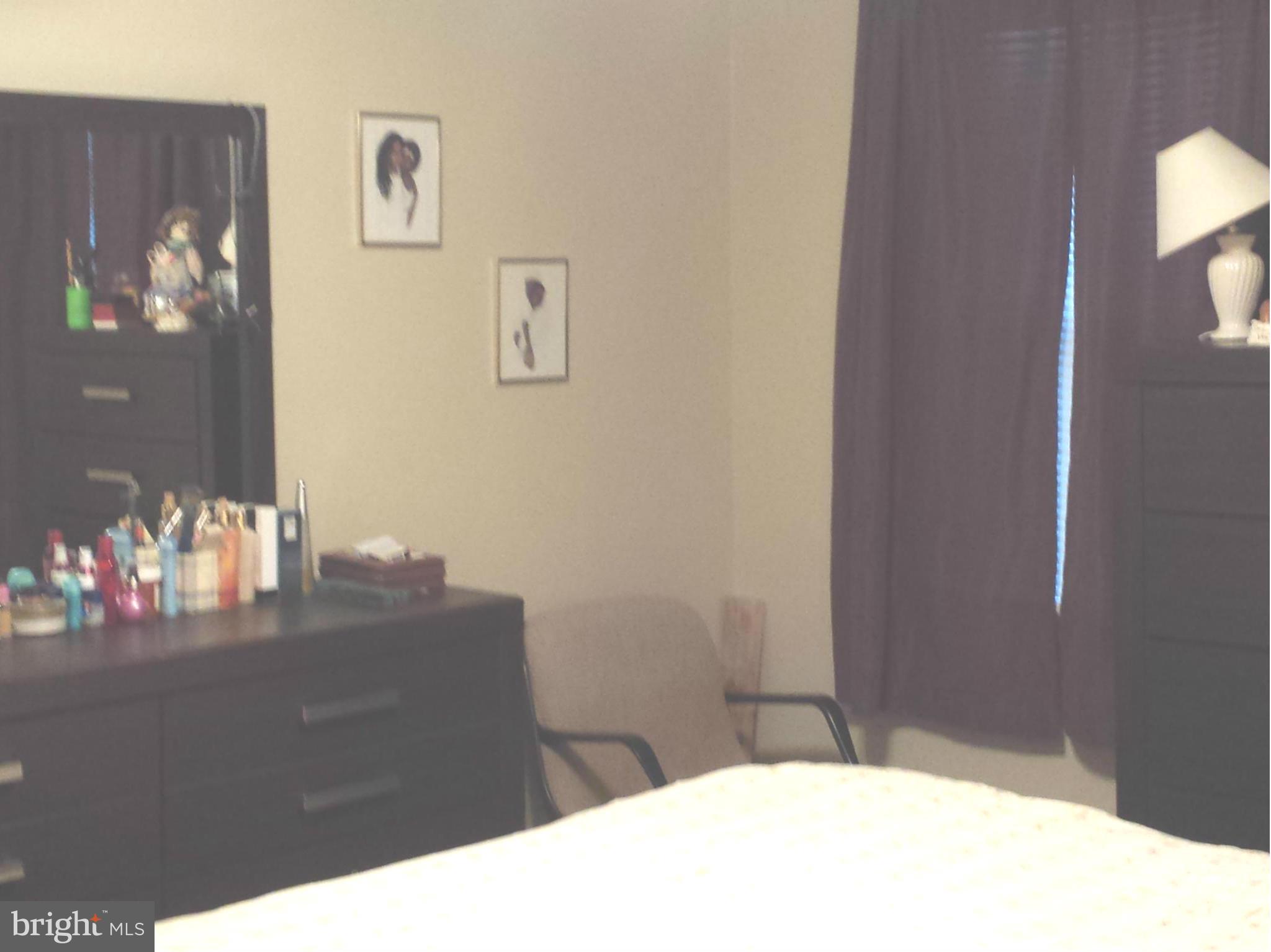 1315 Stonewood Road Baltimore, MD 21239 - Photo 14 of 21 a bedroom with a bed