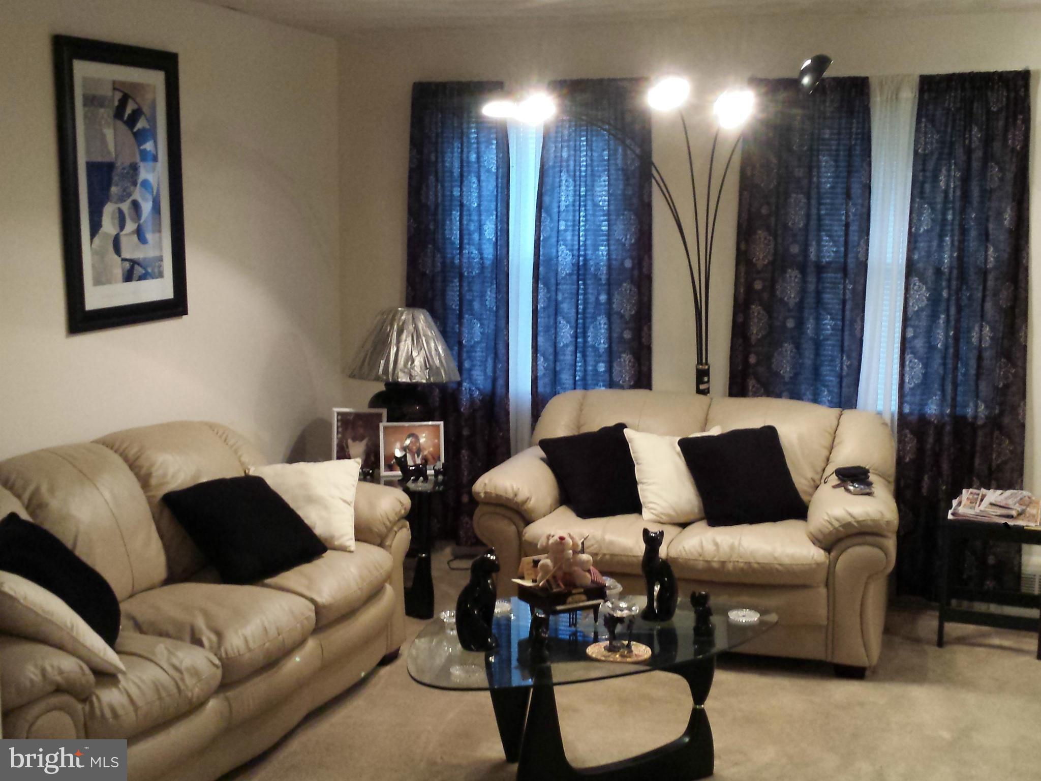1315 Stonewood Road Baltimore, MD 21239 - Photo 3 of 21 a living room with furniture and wooden floor