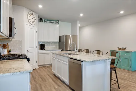 a kitchen with a sink a stove a refrigerator and a refrigerator