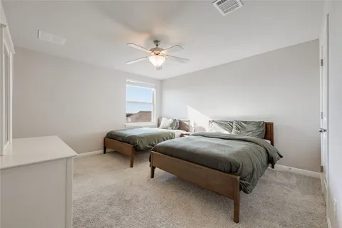 a bedroom with bed and a window