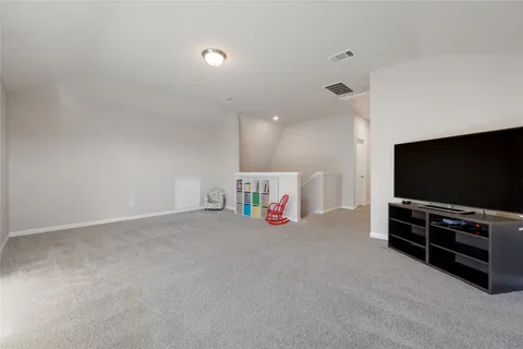 a view of game room with windows and flat screen tv
