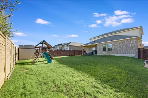 a view of a house with a backyard