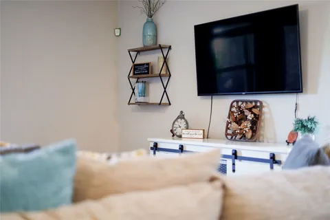 a bathroom with a sink and a flat screen tv