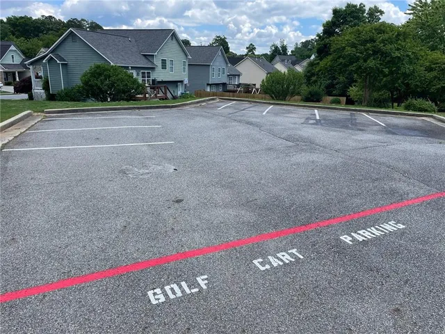 a view of swimming pool with outdoor seating and house in the background