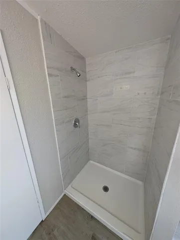 a bathroom with a tub sink and mirror