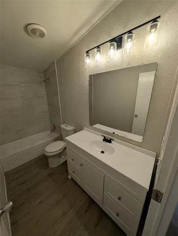 a bathroom with a sink a toilet and mirror