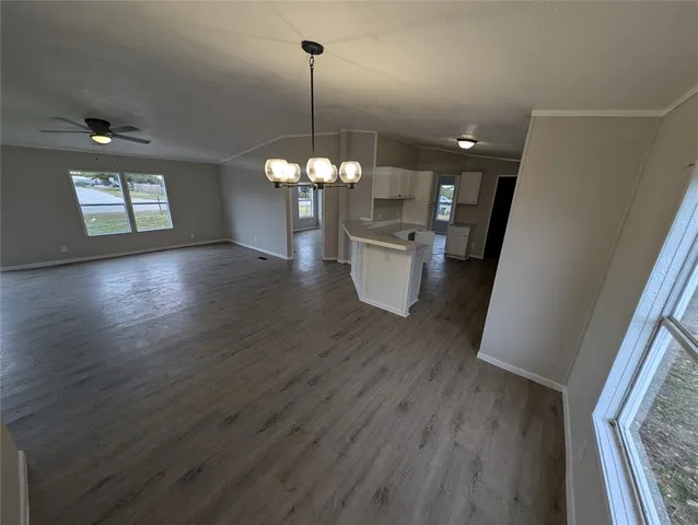 a view of a dining room with furniture wooden floor and chandelier
