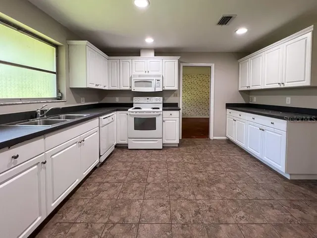 a kitchen with a sink stove and cabinets