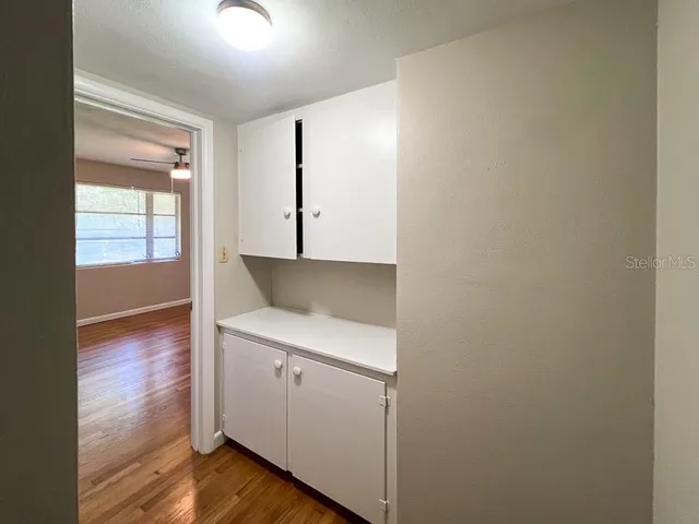 a view of a kitchen with wooden floor and a sink