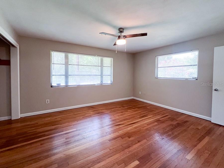 3706 Southwest 2 Place Gainesville, FL 32607 - Photo 14 of 25 a view of empty room with wooden floor and fan