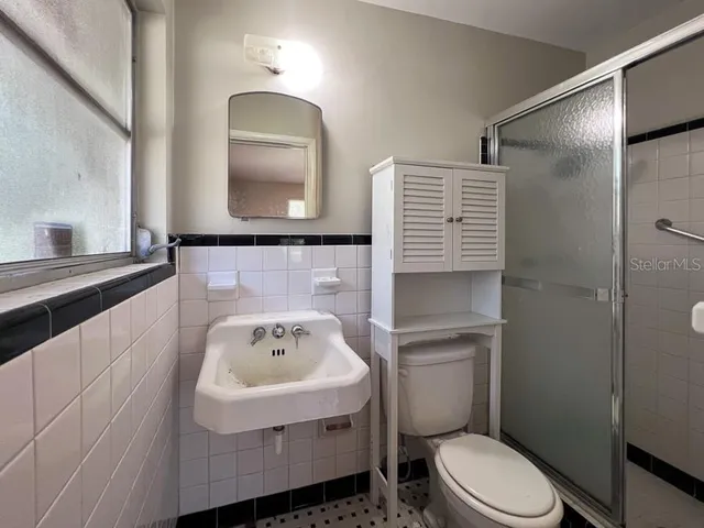 a bathroom with a sink toilet and mirror