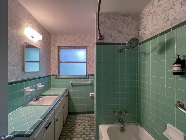 a bathroom with a sink toilet and mirror