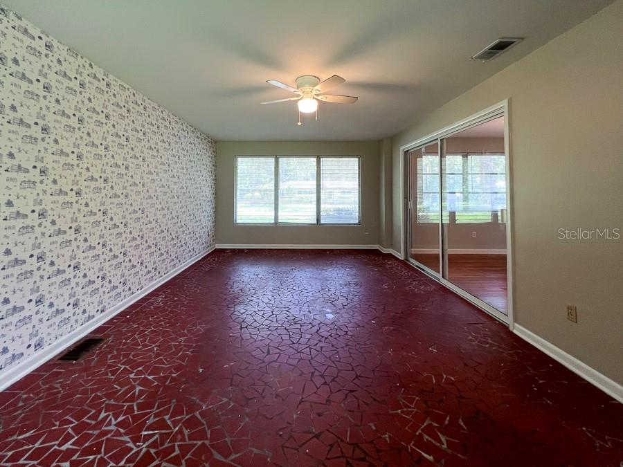 3706 Southwest 2 Place Gainesville, FL 32607 - Photo 6 of 25 a view of empty room with wooden floor and fan