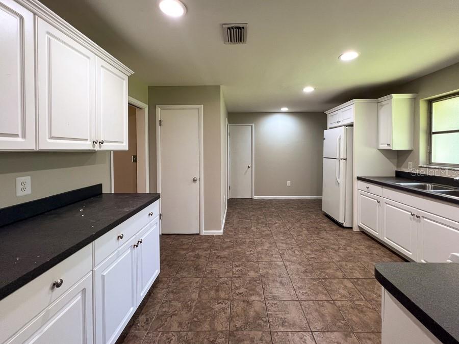 3706 Southwest 2 Place Gainesville, FL 32607 - Photo 8 of 25 a large kitchen with cabinets