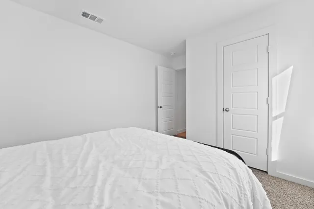 a large white bed in a white room