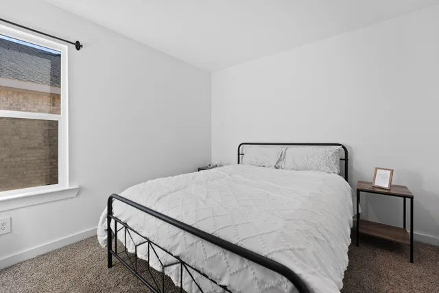 a bedroom with a bed and window