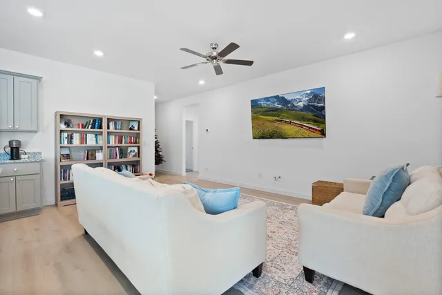 a living room with furniture and a book shelf