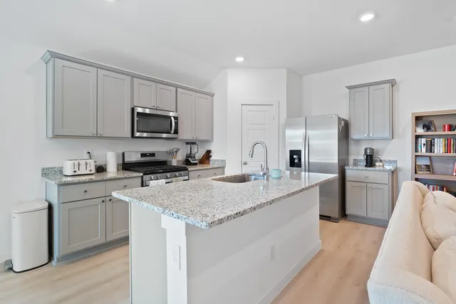 a kitchen with a sink stove and refrigerator