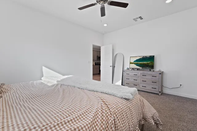 a bedroom with a bed and a flat screen tv