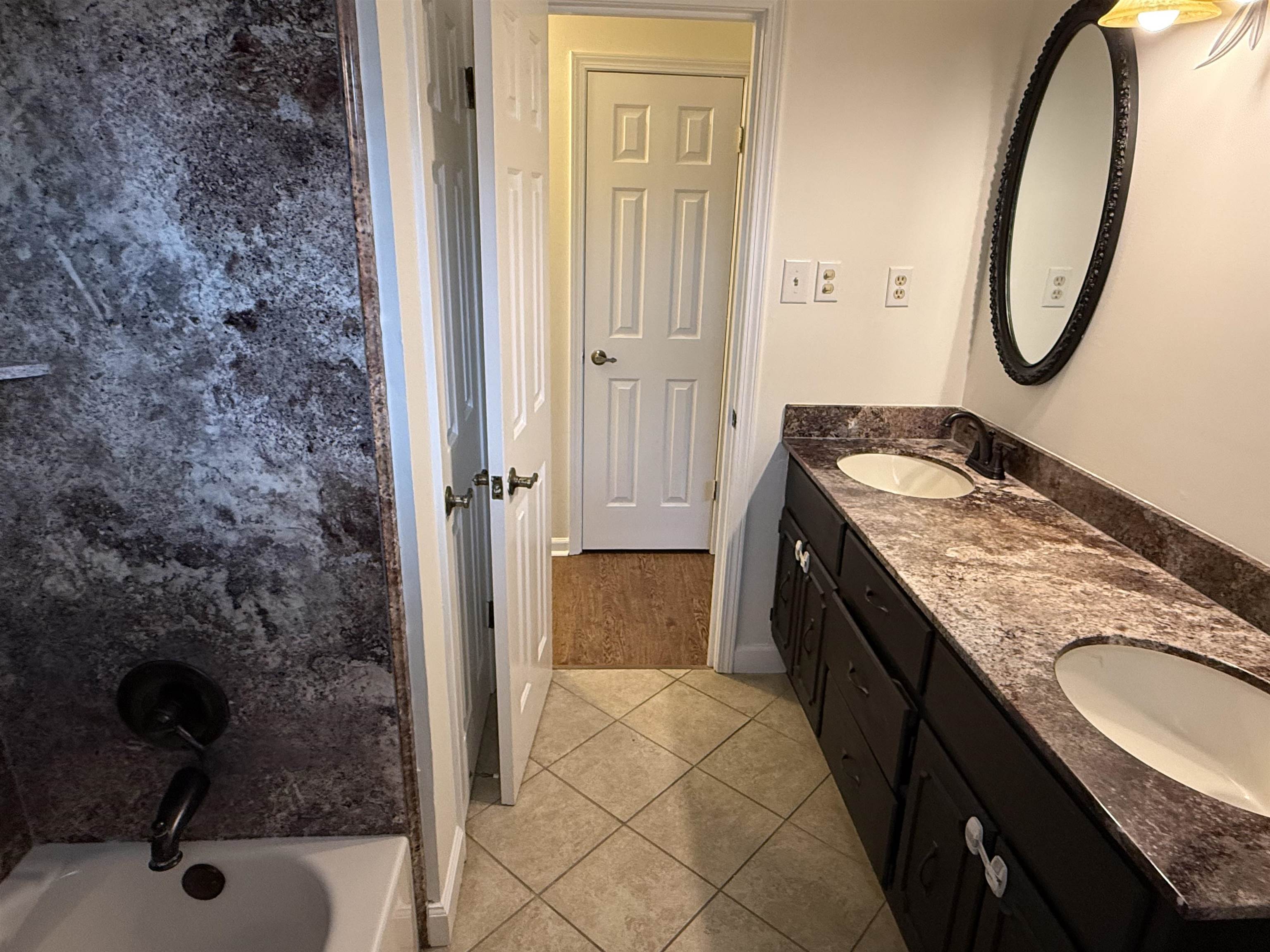 2639 Cedar Ridge Drive Germantown, TN 38138 - Photo 13 of 17 a bathroom with a granite countertop sink a mirror and shower