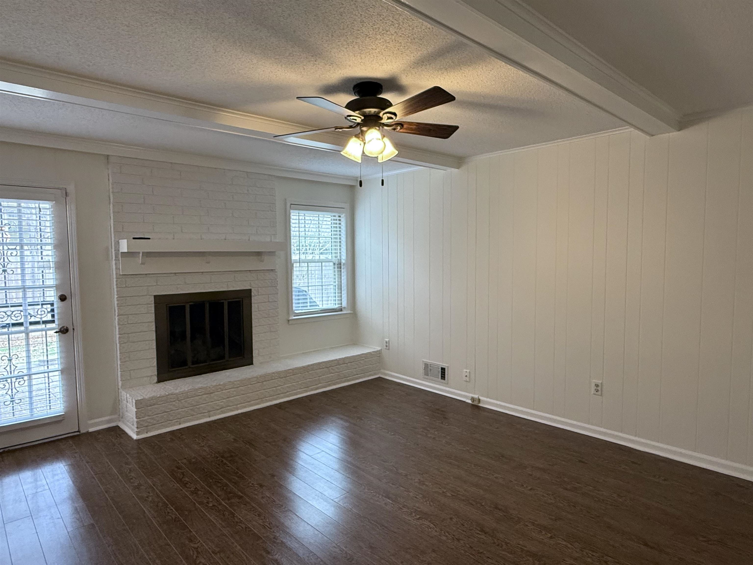 2639 Cedar Ridge Drive Germantown, TN 38138 - Photo 10 of 17 a view of an empty room with wooden floor fireplace and a window