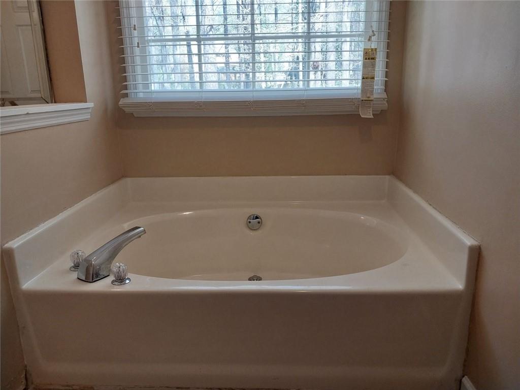 4820 Westbourne Drive Powder Springs, GA 30127 - Photo 11 of 16 a bathroom with a bathtub