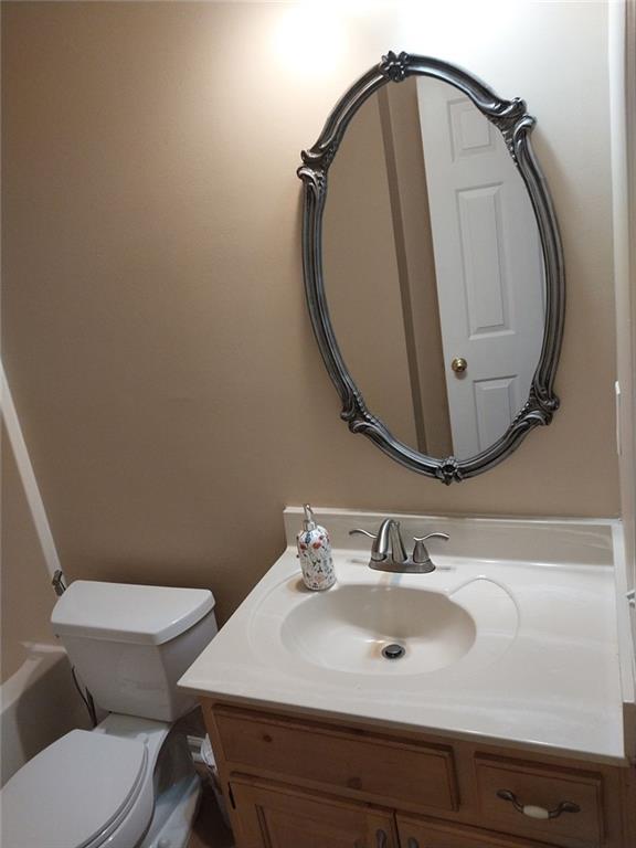 4820 Westbourne Drive Powder Springs, GA 30127 - Photo 15 of 16 a bathroom with a sink mirror and toilet