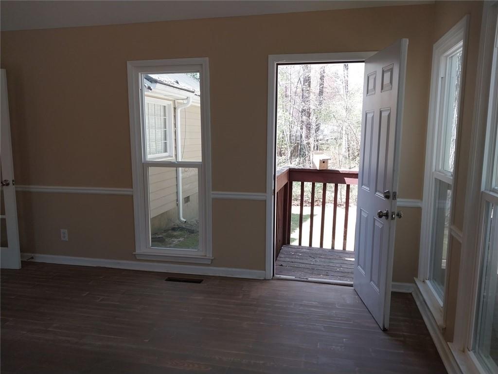 4820 Westbourne Drive Powder Springs, GA 30127 - Photo 4 of 16 an empty room with wooden floor and windows